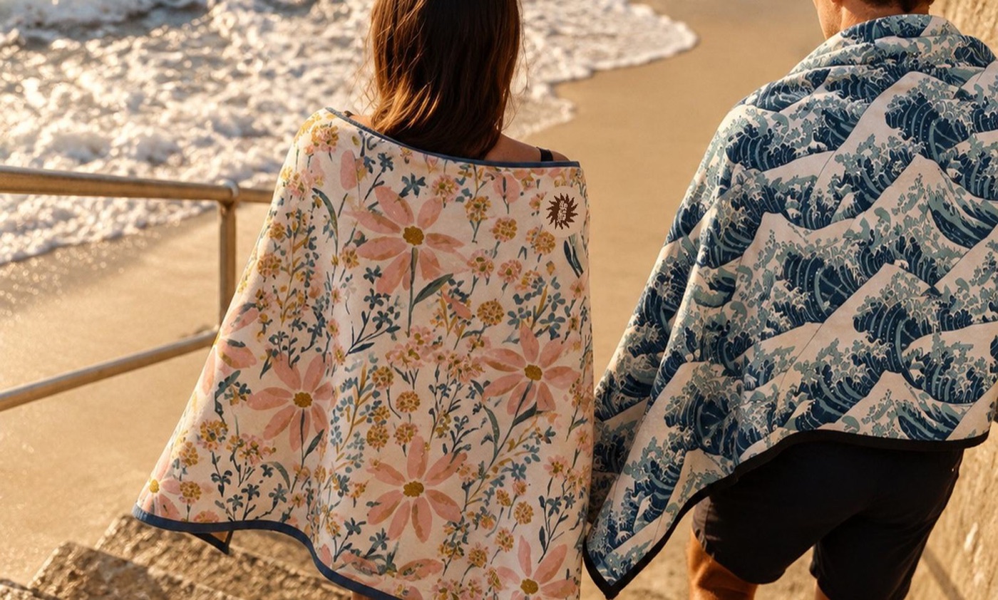 Two friends in Beach Republic towels walking down to the water in the late light